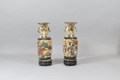 null Pair of Nanking sandstone vases decorated with warriors and horsemen.

China,...