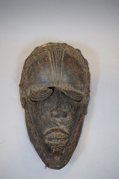 null Wooden mask with a beautiful brown patina highlighting the veins of the wood,...
