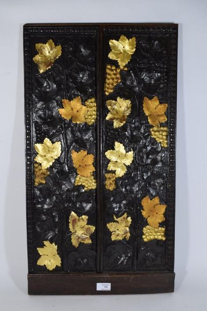 null Wooden panel carved in light relief and partially gilded with vine branches...