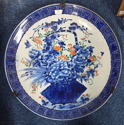 null Large porcelain dish with blue decoration enhanced with polychrome, representing...
