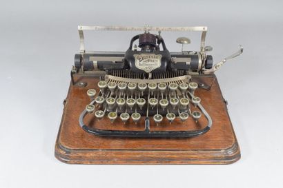 null DACTYLE
Typewriter No. 3 on its wooden stand with removable protective cover....