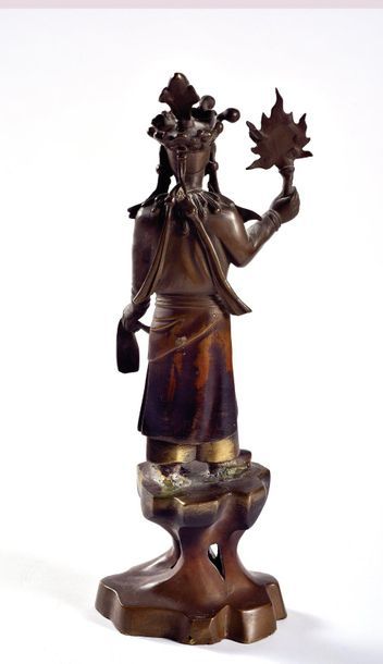 null VIETNAM - Around 1900

Statuette of a figure standing on a bronze base with...