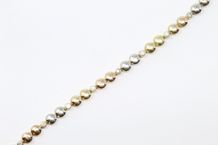 null FRED 

18K (750) yellow and white gold bracelet articulated with plain lozenges...