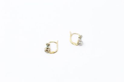 null Pair of 18k (750) yellow gold sleeper earrings, each decorated with a diamond...