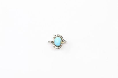 null 18k (750) yellow and white gold ring set with a turquoise cabochon in a ring...