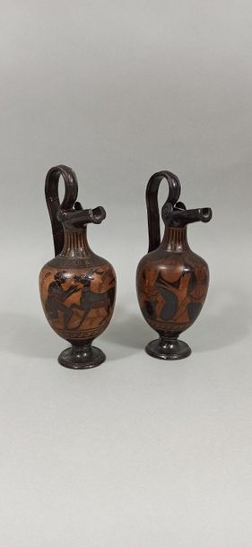  Set of two oenochoes with gutter spout and high rigid handle. The scenes show for...