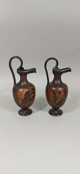  Set of two oenochoes with gutter spout and high rigid handle. The scenes show for...