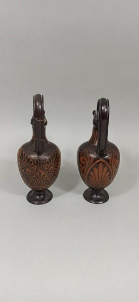 null Set of two oenochoes with gutter spout and high rigid handle. The scenes show...
