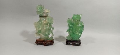 null CHINA - 20th century

Two small covered fluorite vases, with carved decoration...