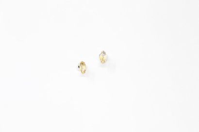 null Pair of silver ear studs each decorated with a shuttle citrine. 

Gross weight:...