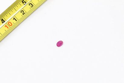 null Oval ruby. 

Probably Mozambique. 

Weight: approx. 0.85 ct. 

A metal frame...