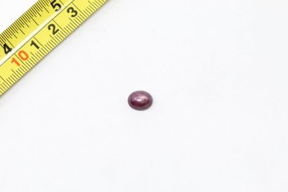 null Star ruby cabochon. 

Weight: 4.01 cts. 

A metal frame is attached to it. 
