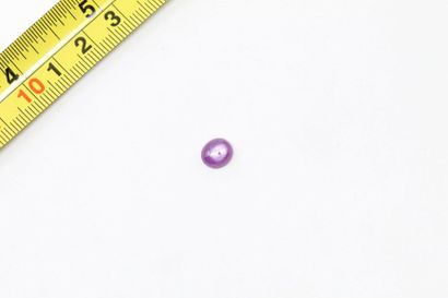 null Ruby cabochon. 

Probably unheated. 

Weight: approx. 2.50 cts. 

A metal frame...