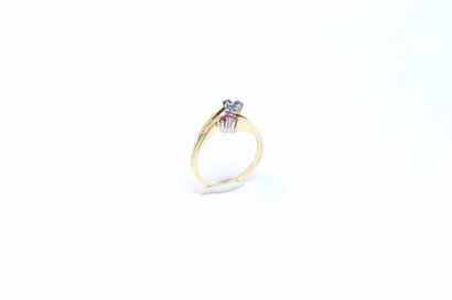 null Ring set with three rubies and three round sapphires stylizing two flowers....
