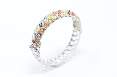 null Rigid silver bracelet adorned with multicoloured sapphires and ornamental stones...