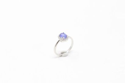 null Silver ring set with an oval tanzanite in a white stone surround. 

Finger size:...