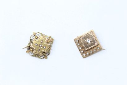 null Set of two 18k (750) yellow gold brooches, one adorned with white stones, the...