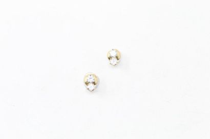 null Pair of 18k (750) yellow and white gold earrings, each adorned with two diamonds....