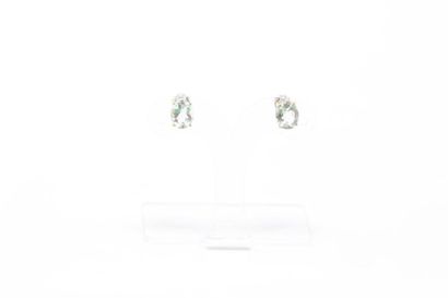 null Pair of silver and vermeil ear studs each decorated with an oval aquamarine....
