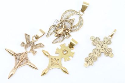 null A set of 18k (750) and 14k (585) yellow gold pendants composed of three crosses...