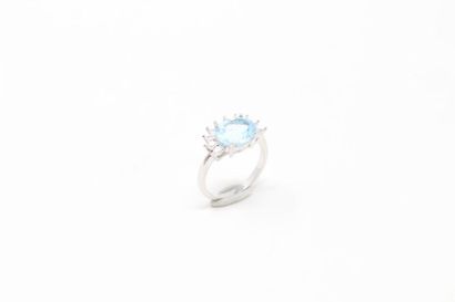 null Silver ring set with an oval blue topaz in a half moon white stone setting.

Finger...