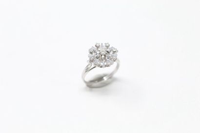 null 18k (750) white gold openwork ring set with a brilliant in a smaller setting....
