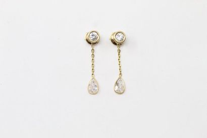 null Pair of 18k (750) yellow gold earrings adorned with two brilliant-cut diamonds...