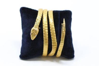 null 18k (750) braided gold snake bracelet, two diamonds set on the head forming...