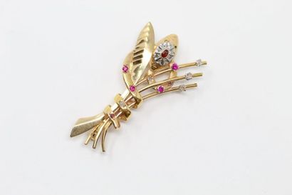 null 18k (750) yellow gold brooch made of a snake entwining a stylized sheaf and...