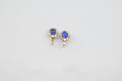 null Pair of earrings decorated with blue imitation stones and white stones (missing)....