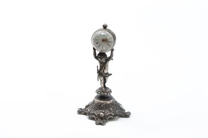null Silver quadripod clock representing a love holding a globe, round dial with...