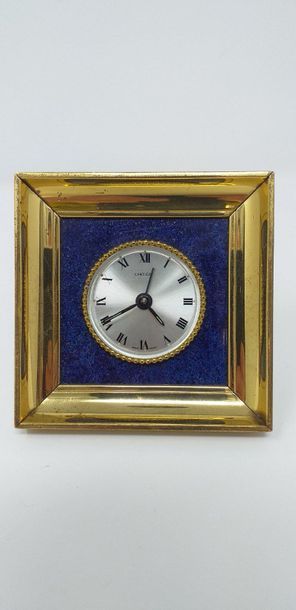 CARTIER CARTIER 

Square gilded brass clock, painted background imitating Lapis-Lazuli....