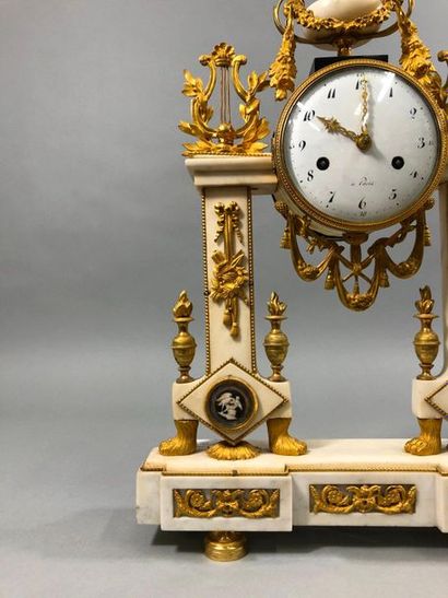 null A white marble and gilt bronze clock in the form of a portico, the dial with...