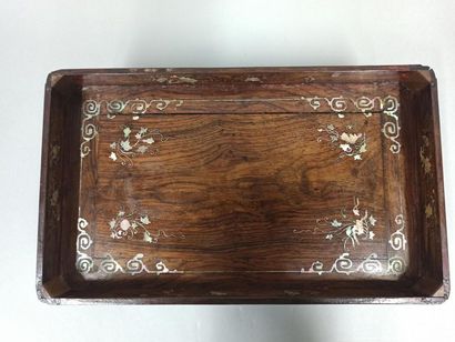 null Rectangular wooden tray inlaid with mother-of-pearl resting on four legs. Decorated...