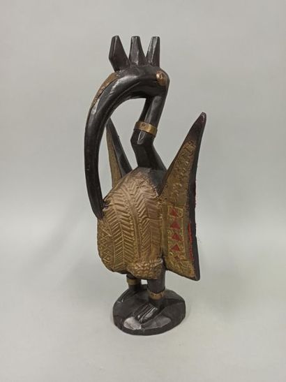 null Statue representing a humanized hornbill with a serrated crest, made of wood...