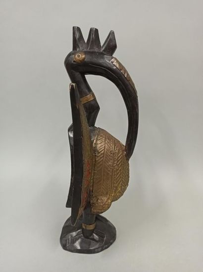 null Statue representing a humanized hornbill with a serrated crest, made of wood...