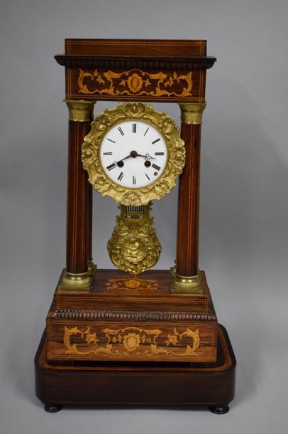 null Portico clock in rosewood veneer, light wood fillets and inlaid decoration of...