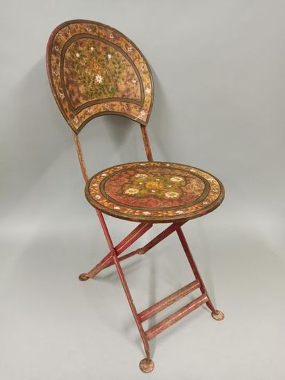 null Folding chair made of painted sheet metal with a flower decoration in a frame.

Late...