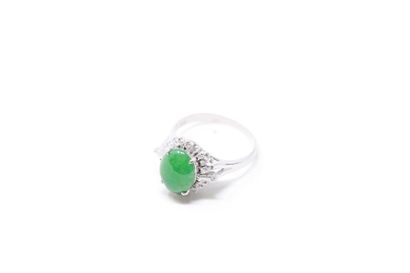 null 
Platinum ring adorned with an oval jadeite cabochon (untested) set with tapers...