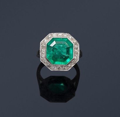 null Platinum ring set with an octagonal emerald in a frame of twenty brilliants....