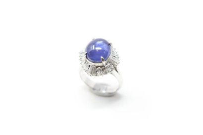 null Platinum ring set with a blue-violet sapphire cabochon shimmering in a setting...