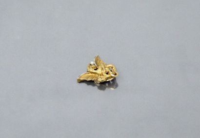 null Buttonhole brooch in 18k (750) yellow gold featuring a winged dragon holding...