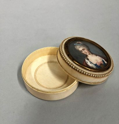 null Set of two circular ivory boxes, the lid surmounted by a miniature representing...