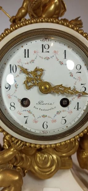 null White marble and gilt bronze clock, circular dial supported by two puttis and...