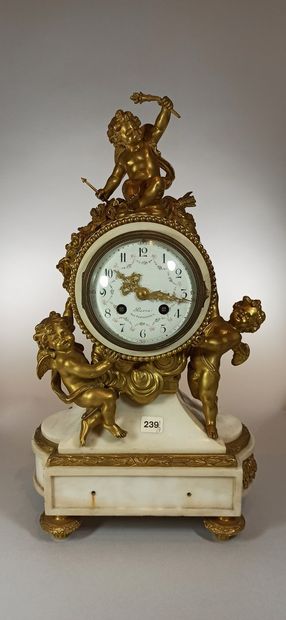 null White marble and gilt bronze clock, circular dial supported by two puttis and...