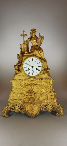 null Gilt bronze clock surmounted by a woman on Calvary, decorated with foliage and...