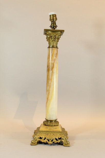 null Lamp base in the shape of a Corinthian column in onyx and gilt bronze. 

Ht.:...