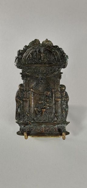 null Bronze Kiss of Peace depicting the Virgin and Child sitting under a shell, with...