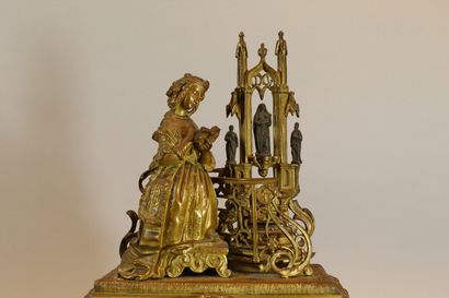 null Romantic gilt bronze clock with a young woman praying in front of an altar....