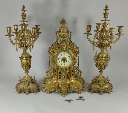 null Important chased bronze neo-Gothic mantel set consisting of a clock, cream enameled...